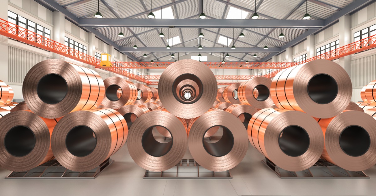 A view of a large facility with hundreds of large copper sheets and copper tapes stacked together in rolls.