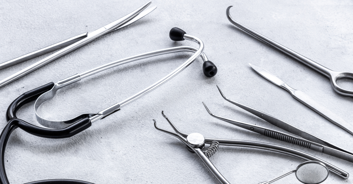 Surgical equipment made from medical-grade stainless steel is next to a stethoscope used for general practice.