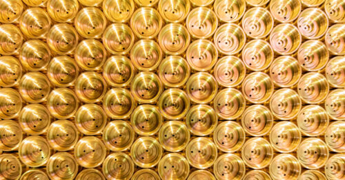 Here's a close-up of shiny brass metal parts aligned together. The brass looks brand new and reflects light well.