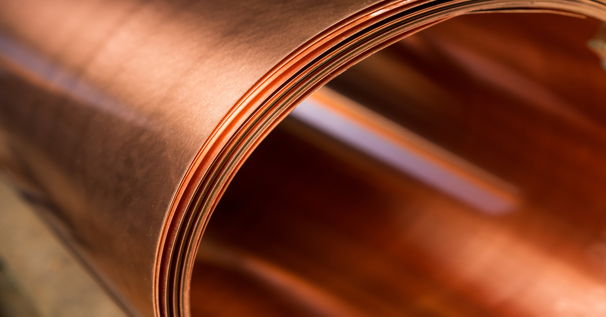 A small roll of quality copper sheets. There are multiple layers of this sheet tightly rolled together.
